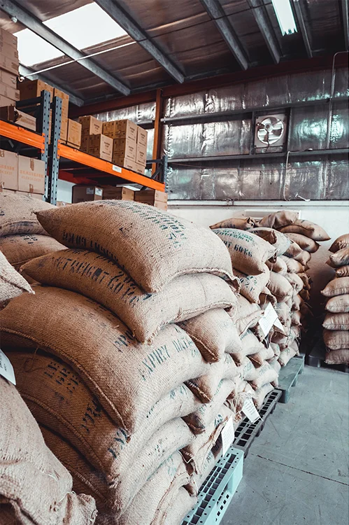Burlap sacks of green coffee in the Boon warehouse