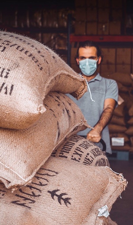 The Boon team moving burlap sacks of coffee